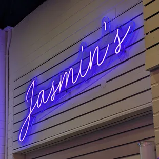a neon sign on the side of a building