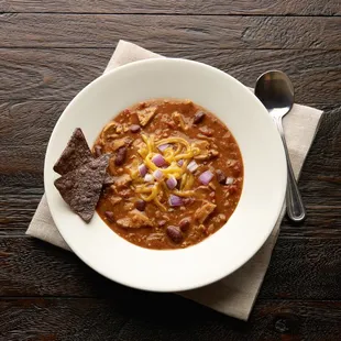 a bowl of chili and tortilla