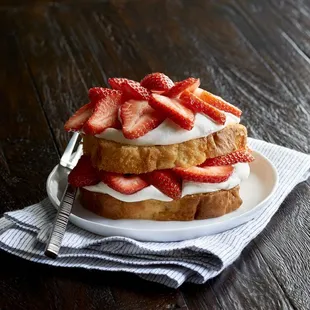 a stack of strawberries and whipped cream