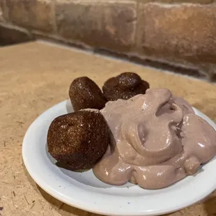 a plate of chocolate pudding and strawberries