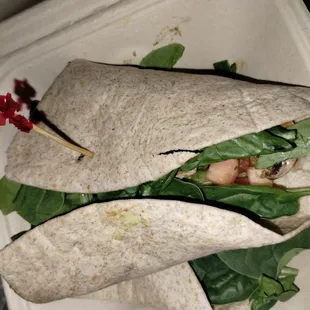 a burrito in a styrofoam container