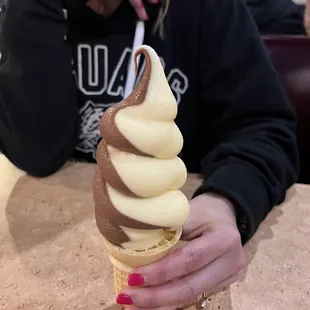 a woman holding a cone of ice cream