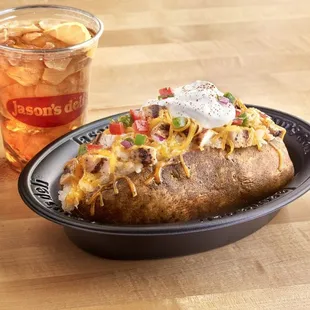 a loaded baked potato and a drink