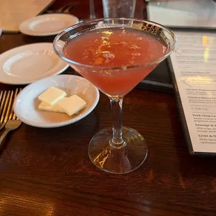 a glass of wine and a plate of butter