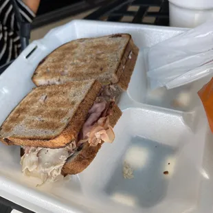 a sandwich and a drink on a tray