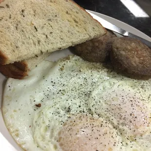 Simple but great breakfast of perfectly cooked over easy to gas sausage and rye toast