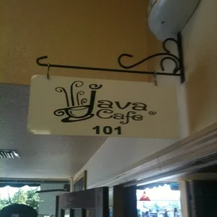 a sign hanging from the side of a building