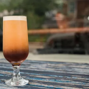 a glass of coffee on a table
