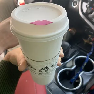 a starbucks cup in a car