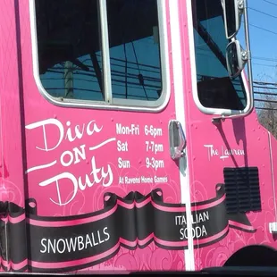 a pink food truck parked in a parking lot