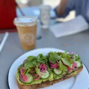 a sandwich with avocado and radishes