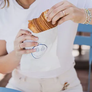 a woman eating a croissant