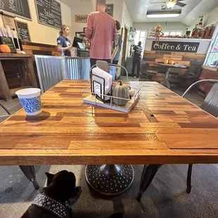 a table with a cup of coffee and a laptop on it