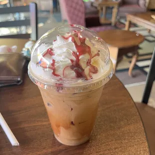 a cup of iced coffee on a table