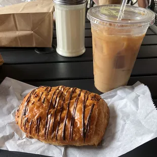 Large iced coffee and chocolate croissant