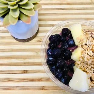 a bowl of oatmeal with blueberries and bananas