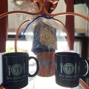 two coffee mugs on a shelf