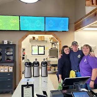 a group of people standing in front of a counter