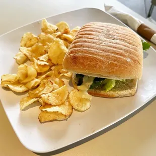 a sandwich and chips on a plate