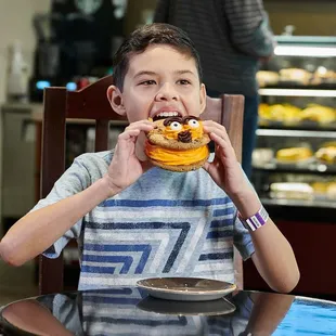 a young boy eating a doughnut