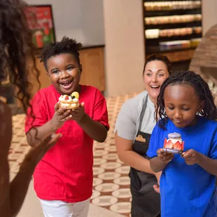 a group of people in a bakery