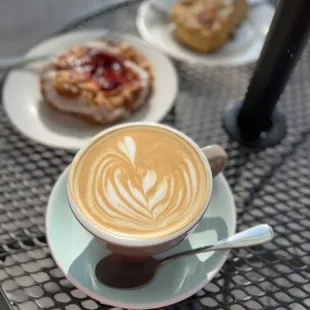 Flat white with pastries; strawberry danish and cheese scone.