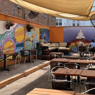 Outdoor seating with music and a bar