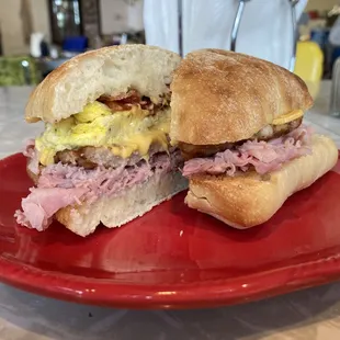 a ham and egg sandwich on a red plate