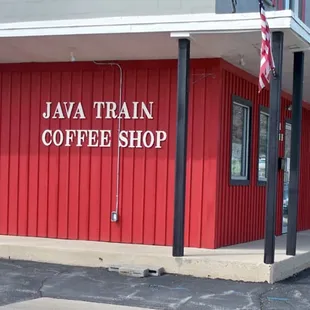 a red building with a sign that says java train coffee shop