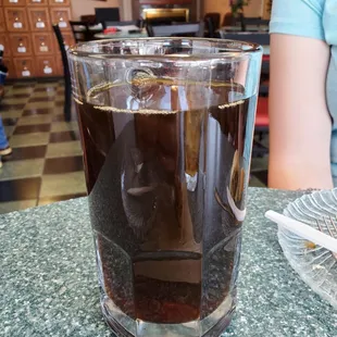 a glass of iced coffee on a table