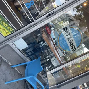 a blue chair outside a restaurant