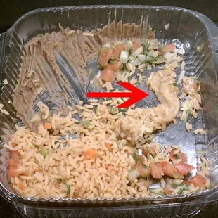 Unfinished fish taco meal, with arrow pointing to raw chicken meat/fat found in the rice.