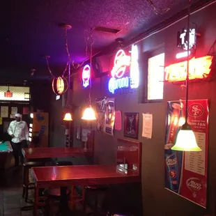 a pool table and neon signs