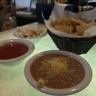 Complimentary sauce and bean dip and cheese
