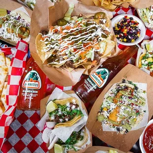 a table full of tacos and other tacos