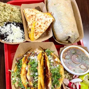 a variety of tacos, rice, and salsa