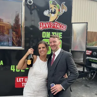 My husband and I on our wedding day with Javi's food truck