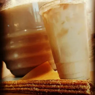 a cup of coffee and a stack of churros