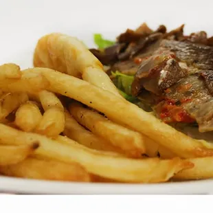 a plate of french fries and a steak sandwich