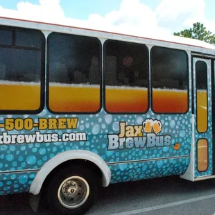 a beer bus parked in a parking lot