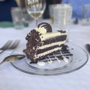 a slice of chocolate cake on a glass plate