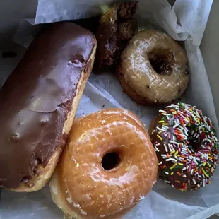Chocolate bar, glazed donut, chocolate cake with sprinkles, blueberry donut