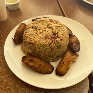 a plate of fried rice and potatoes