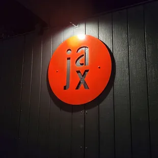 a red sign on a black wall