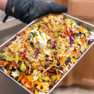 a person holding a tray of food