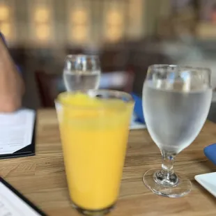 a glass of orange juice and a glass of water