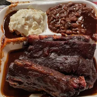 Dinner - Large Rib Plate smothered in Hot sauce with baked beans + potato salad; 2 slices of white bread on the side