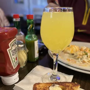 a plate of food and a glass of juice