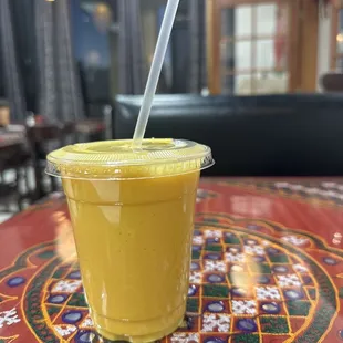 a smoothie in a plastic cup on a table