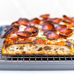 a pizza on a cooling rack